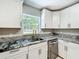 Kitchen area featuring granite countertops, stainless steel dishwasher, and white cabinetry at 4887 Seminole Ave, Winter Park, FL 32792