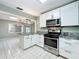 Open kitchen design with granite countertops, stainless steel appliances, and breakfast bar at 4887 Seminole Ave, Winter Park, FL 32792