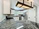 Modern kitchen with granite countertops, stainless steel appliances, and contemporary lighting at 4887 Seminole Ave, Winter Park, FL 32792