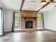Comfortable living room features a brick fireplace and wood-look flooring at 4887 Seminole Ave, Winter Park, FL 32792