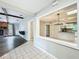 Open-concept layout connecting the dining area with a fireplace and view of the kitchen at 4887 Seminole Ave, Winter Park, FL 32792