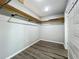 View of large walk-in closet with wood shelving and hanging rack at 4887 Seminole Ave, Winter Park, FL 32792