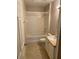 Clean bathroom with a shower/tub combo, white cabinets, and neutral tiling at 5550 E Michigan St # 2114, Orlando, FL 32822