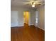 Spacious bedroom with wood floors, ceiling fan, and access to a walk-in closet at 5550 E Michigan St # 2114, Orlando, FL 32822