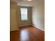 Comfortable bedroom with wood floors and natural light from a window at 5550 E Michigan St # 2114, Orlando, FL 32822
