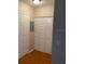 Hallway with hardwood floors, a closet, and a door at 5550 E Michigan St # 2114, Orlando, FL 32822
