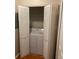 Convenient laundry closet with a washer and dryer and bifold doors for space saving at 5550 E Michigan St # 2114, Orlando, FL 32822