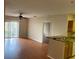 Inviting living room and kitchen combo featuring wood floors and an open layout at 5550 E Michigan St # 2114, Orlando, FL 32822