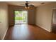 Bright living room with modern ceiling fan and sliding door to outdoor space at 5550 E Michigan St # 2114, Orlando, FL 32822