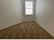 Cozy bedroom with neutral walls, carpet, and a window providing natural light at 5550 E Michigan St # 2202, Orlando, FL 32822
