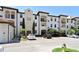 Exterior view of building with multiple units, balconies, and well-maintained landscaping at 5550 E Michigan St # 2202, Orlando, FL 32822