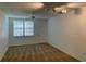 Bright living room featuring neutral walls and carpet, with ample natural light from a large window at 5550 E Michigan St # 2202, Orlando, FL 32822