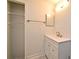 Bathroom with modern vanity, stylish faucet, and ample lighting, complemented by a closet at 5578 Metrowest Blvd # 10, Orlando, FL 32811