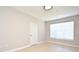 Bright and spacious bedroom with a large window, tile flooring, and a neutral color palette at 5578 Metrowest Blvd # 10, Orlando, FL 32811