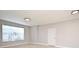 Bright bedroom with neutral walls, large window, tile flooring and a white door at 5578 Metrowest Blvd # 10, Orlando, FL 32811