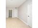 A bedroom featuring neutral walls, tiled floors, and doors leading to the closet at 5578 Metrowest Blvd # 10, Orlando, FL 32811