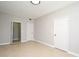 Inviting bedroom featuring tile flooring, fresh paint, two closets, and ample space at 5578 Metrowest Blvd # 10, Orlando, FL 32811