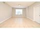 A bedroom displaying neutral walls, tiled floors, a window providing ample light at 5578 Metrowest Blvd # 10, Orlando, FL 32811