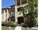 Multi-story condo building with lush landscaping and a covered entryway, perfect for tropical living at 5578 Metrowest Blvd # 10, Orlando, FL 32811