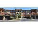 Community with garages, lush landscaping, and a multi-story condo building with a tile roof at 5578 Metrowest Blvd # 10, Orlando, FL 32811