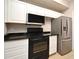 Functional kitchen featuring white cabinetry, black appliances, and sleek countertops for convenient meal preparation at 5578 Metrowest Blvd # 10, Orlando, FL 32811