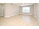 A living room showcasing neutral walls, tiled floors, and windows at 5578 Metrowest Blvd # 10, Orlando, FL 32811