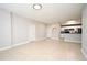 A living room showcasing neutral walls, tiled floors, leading into the kitchen at 5578 Metrowest Blvd # 10, Orlando, FL 32811