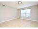 A living room showcasing neutral walls, tiled floors, and windows at 5578 Metrowest Blvd # 10, Orlando, FL 32811