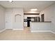 Bright living area with tile flooring, connecting seamlessly to an adjacent kitchen with breakfast bar at 5578 Metrowest Blvd # 10, Orlando, FL 32811