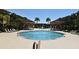 Luxurious pool area with fountains, cabanas, and palm trees for ultimate relaxation at 5578 Metrowest Blvd # 10, Orlando, FL 32811