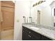 Elegant bathroom featuring granite countertop, a sink, and a bathtub in the background at 615 Clemson Dr, Altamonte Springs, FL 32714