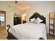 Cozy bedroom with a decorative bed frame, soft carpet, and a view into the Primary bathroom at 615 Clemson Dr, Altamonte Springs, FL 32714