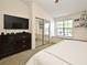 Bright bedroom features a TV, closet with mirrored doors, and natural light at 615 Clemson Dr, Altamonte Springs, FL 32714