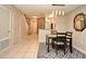 Dining area features tile floors, modern lighting, and access to the staircase at 615 Clemson Dr, Altamonte Springs, FL 32714