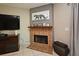 Living room showcasing a charming brick fireplace with a wooden mantle and a cheetah print at 615 Clemson Dr, Altamonte Springs, FL 32714