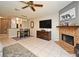 Open-concept living room with a fireplace, tile flooring, and a dining area adjacent to the kitchen at 615 Clemson Dr, Altamonte Springs, FL 32714