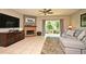 Comfortable living room featuring a brick fireplace, TV, and sliding glass doors to outdoor deck at 615 Clemson Dr, Altamonte Springs, FL 32714