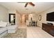 The living room features tile floors, a gray sofa, and a dining area adjacent to the kitchen at 615 Clemson Dr, Altamonte Springs, FL 32714