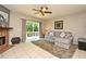 Inviting living room featuring tile floors, a ceiling fan, and sliding glass doors to the backyard deck at 615 Clemson Dr, Altamonte Springs, FL 32714