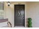 Dark front door with a 'welcome' sign, topiary, and a partial view of porch seating at 623 Dory Ln # 307, Altamonte Springs, FL 32714