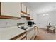 Cozy kitchen features white cabinets and appliances at 623 Dory Ln # 307, Altamonte Springs, FL 32714