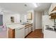 Bright kitchen with white appliances, wooden accents, and a convenient breakfast bar at 623 Dory Ln # 307, Altamonte Springs, FL 32714