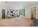 Spacious living room with a couch, glass table, ceiling fan, and a glimpse of the laundry room at 623 Dory Ln # 307, Altamonte Springs, FL 32714