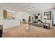 Open living room and kitchen area with neutral carpet, ceiling fan, and modern decor at 623 Dory Ln # 307, Altamonte Springs, FL 32714