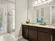 Stylish bathroom featuring a glass-enclosed shower, granite countertops, and tasteful floral accents for a spa-like retreat at 645 American Holly Pl, Oviedo, FL 32765
