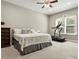 Cozy bedroom with a comfortable bed, a treadmill by the window and a dark wooden dresser at 645 American Holly Pl, Oviedo, FL 32765