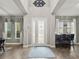 Welcoming foyer featuring wood-look floors, high ceilings, and an elegant front door at 645 American Holly Pl, Oviedo, FL 32765