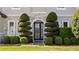 Beautifully landscaped front entrance with decorative shrubbery and a glass-paneled door at 645 American Holly Pl, Oviedo, FL 32765