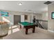Bright game room featuring a pool table and bar area, perfect for entertaining guests and unwinding after a long day at 645 American Holly Pl, Oviedo, FL 32765