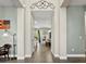 Hallway with wood-look floors leading to a dining area with pool views at 645 American Holly Pl, Oviedo, FL 32765